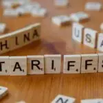 Wooden letter blocks spelling tariffs, China, and USA representing trade relations.